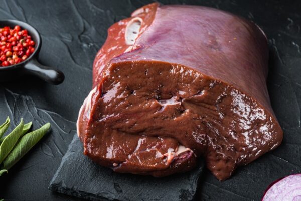 Raw,Beef,Liver,On,Black,Background.